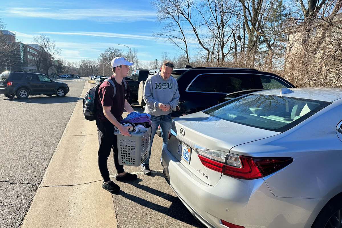 student packing up car