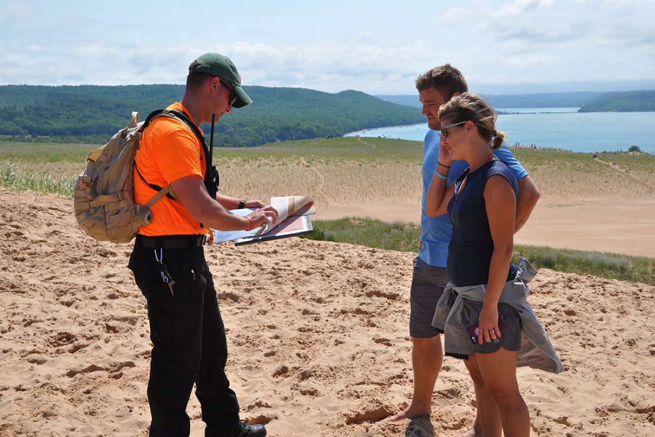 two volunteers with lakeshore in the background