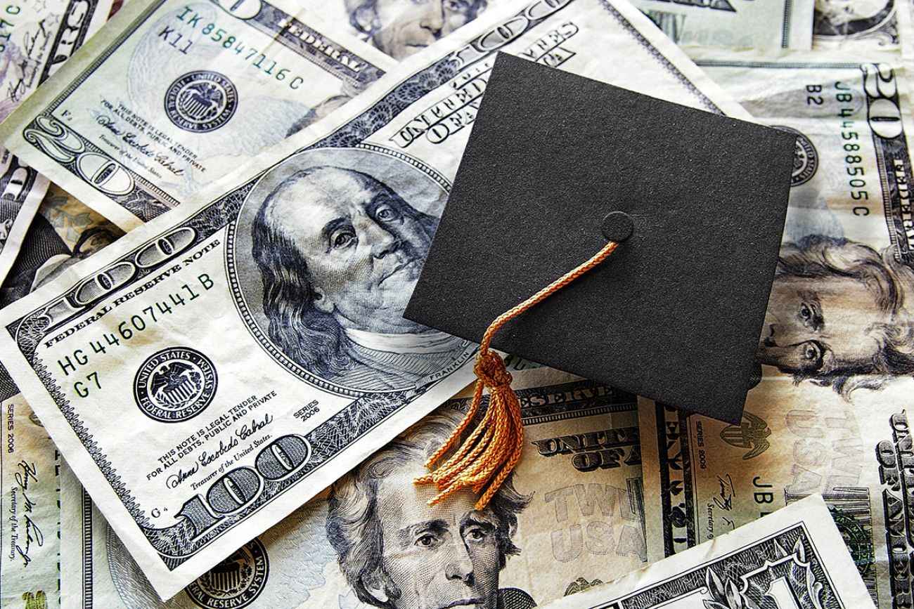 graduation hat on pile of money