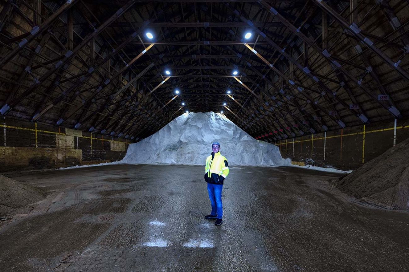 man in front of salt pile