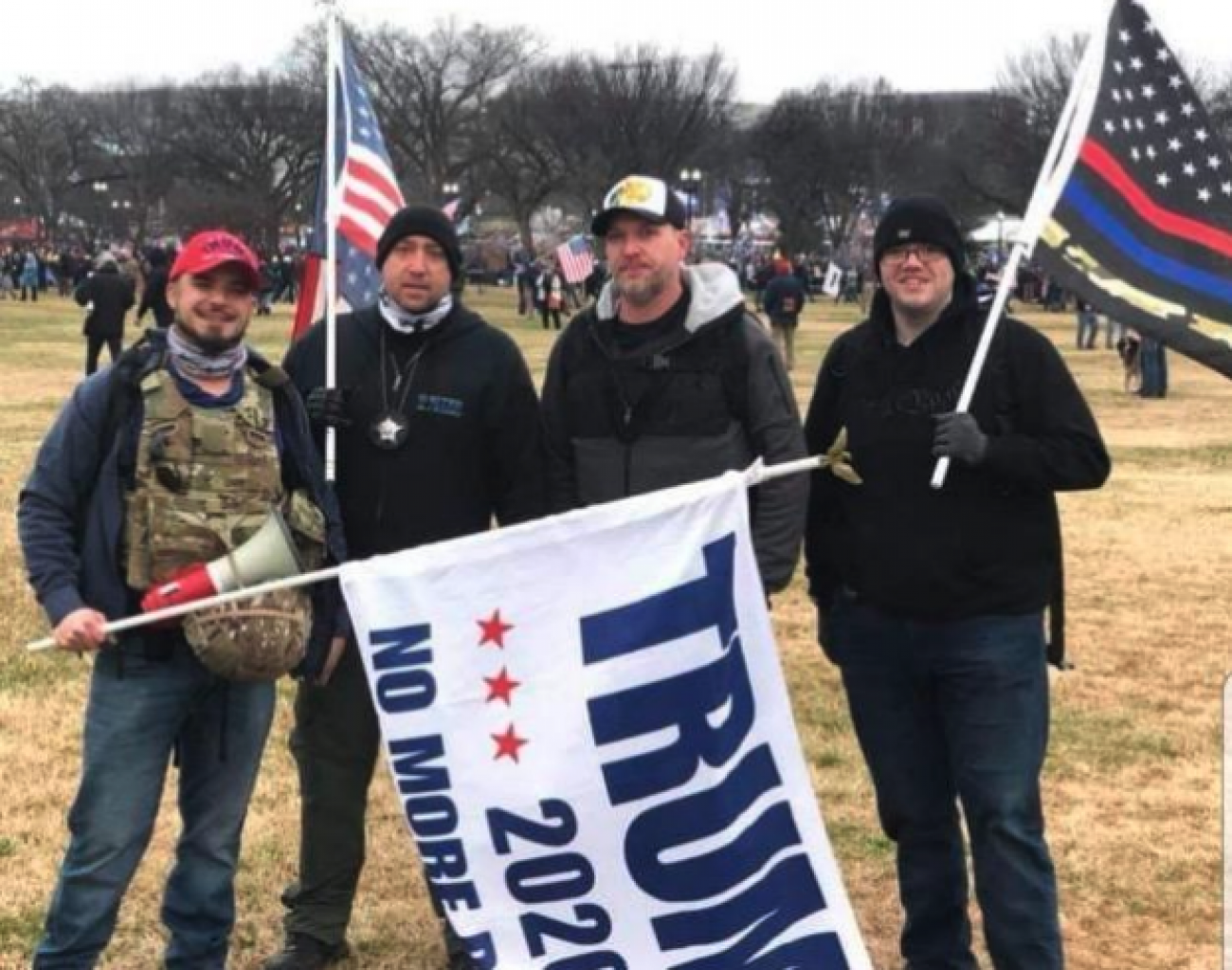 people holding a Trump flag