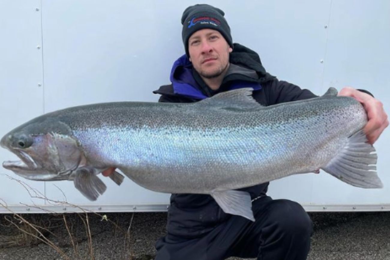 Man holds fish.