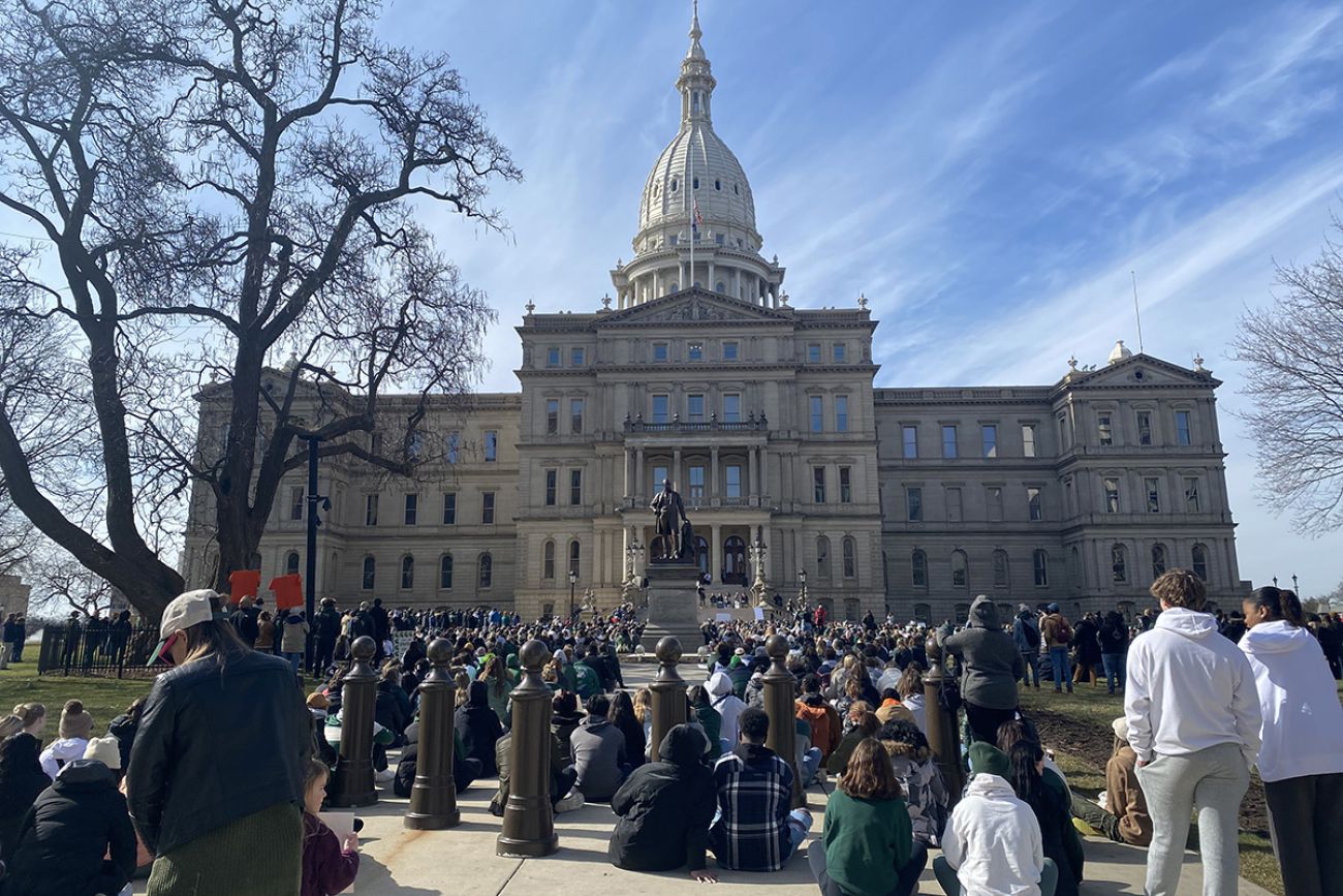 Several hundreds of MSU students protest at the Capitol on a sunny day