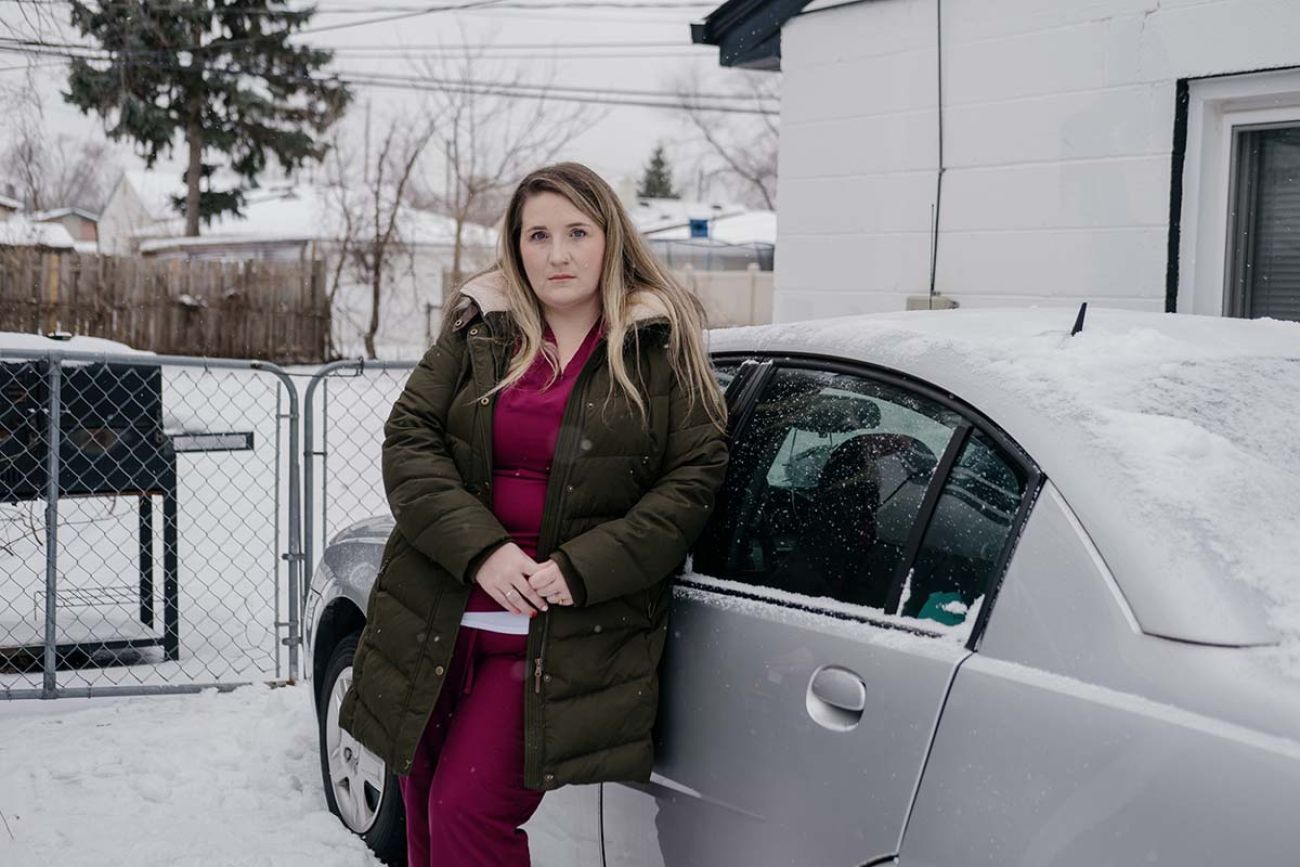 woman standing next to car