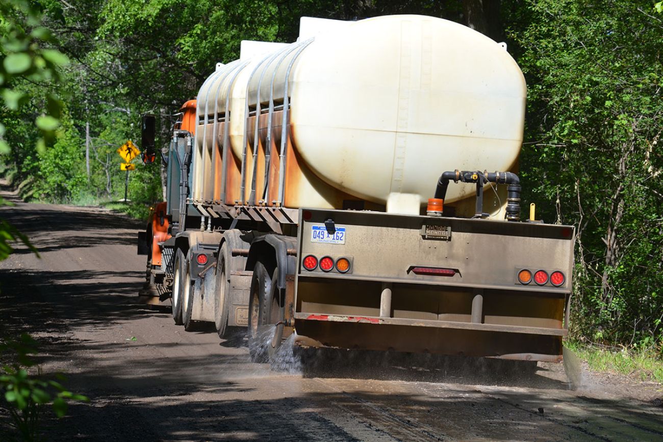 truck spraying brine on the road