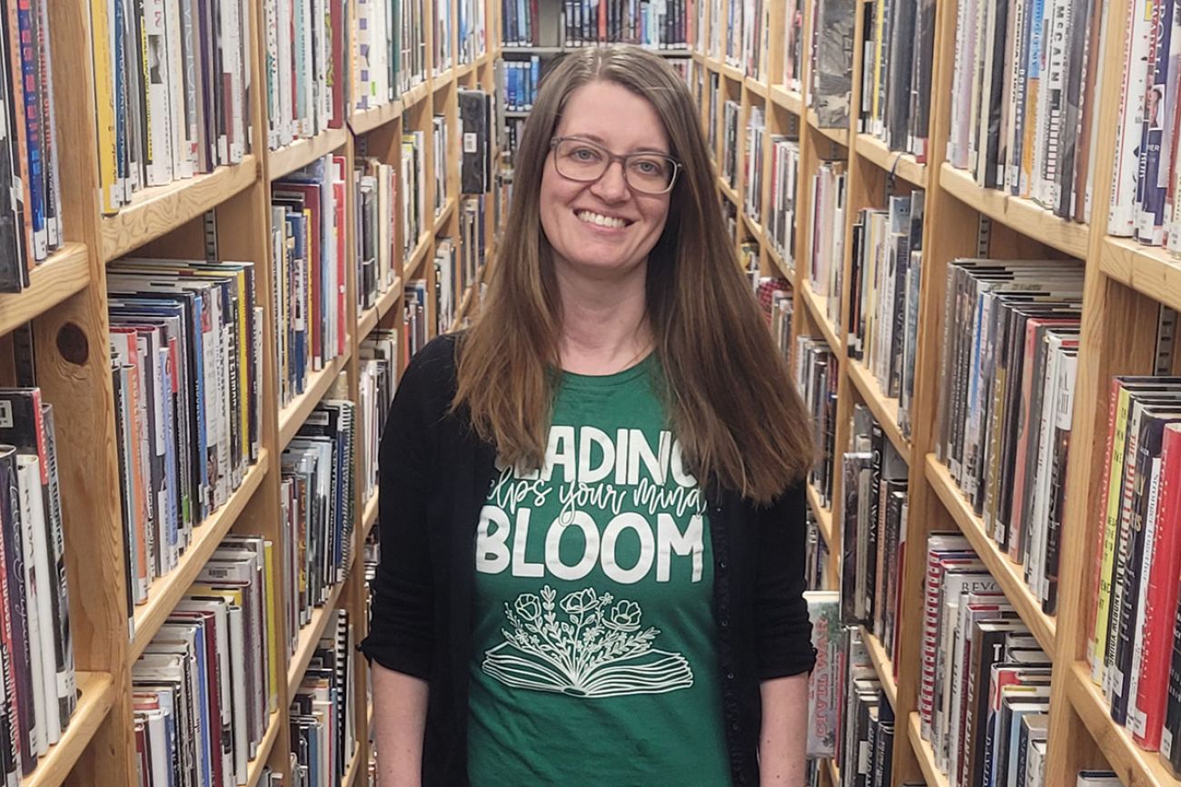 Patricia Buckhold flanked by book shelves