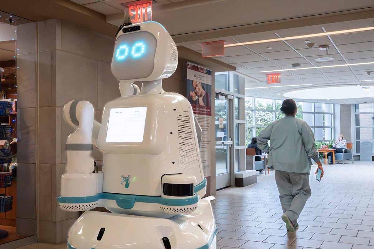 robot in the hallway; someone walking in the background