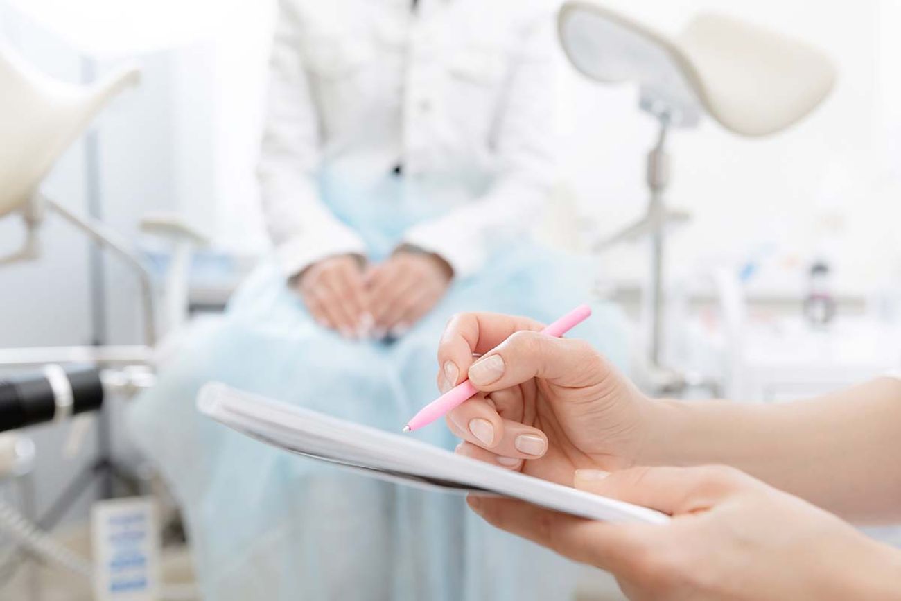 Young woman patient at gynecologist appointment consults in medical institution.