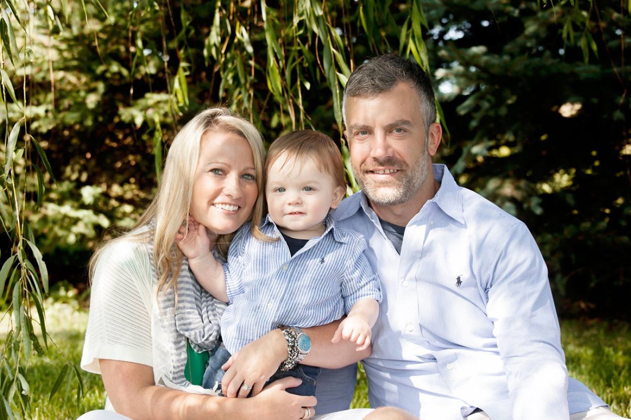 Kelsey Warshefski posing for a photo with her husband and son