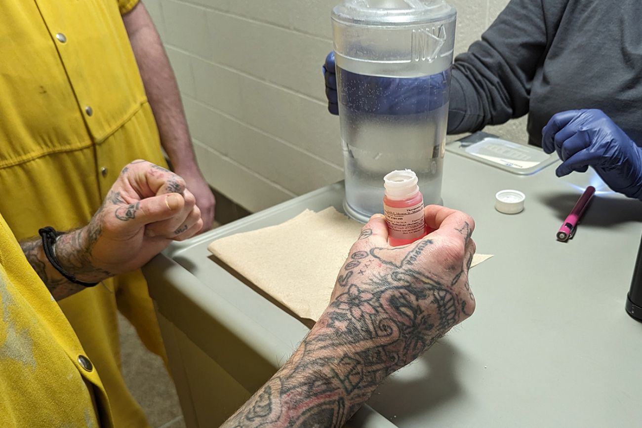 a close up of someone's hands holding medicine 