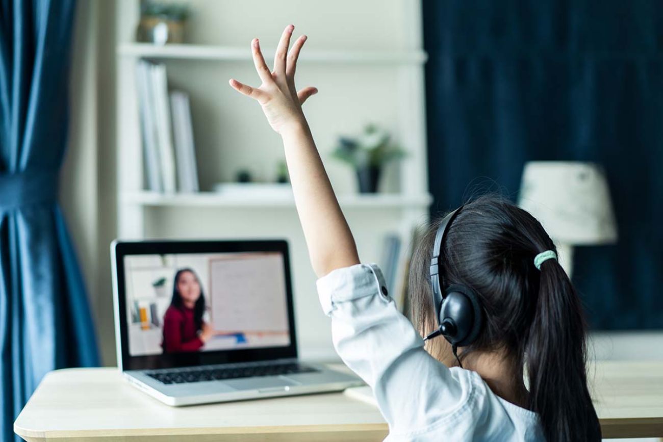 little young girl student learning virtual internet online class from school teacher by remote meeting