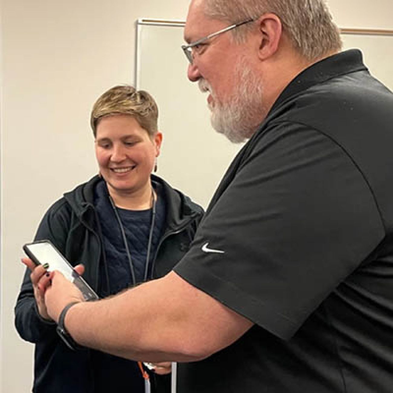 woman holding phone to man