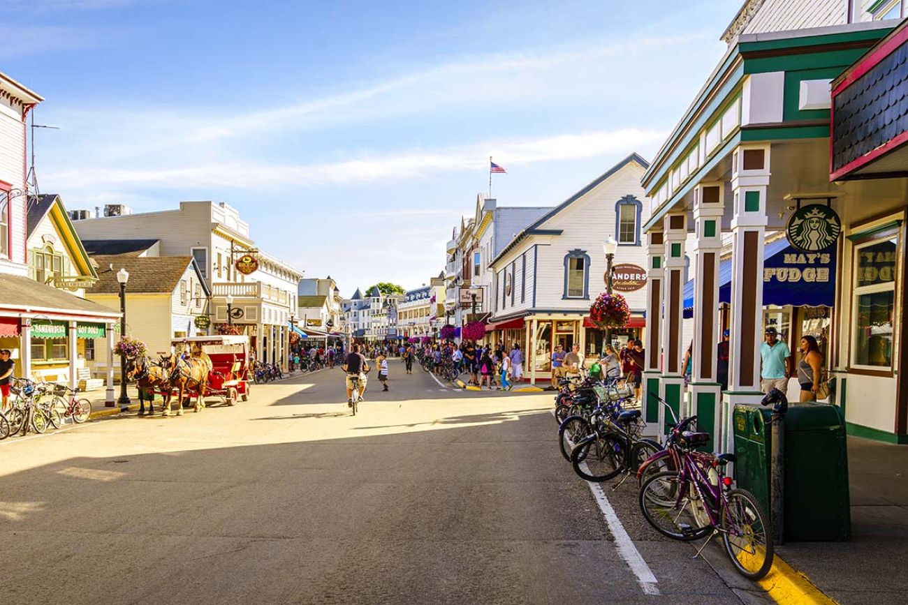 Vacationers take on Market Street on Mackinac Island that is lined with shops and restaurants.