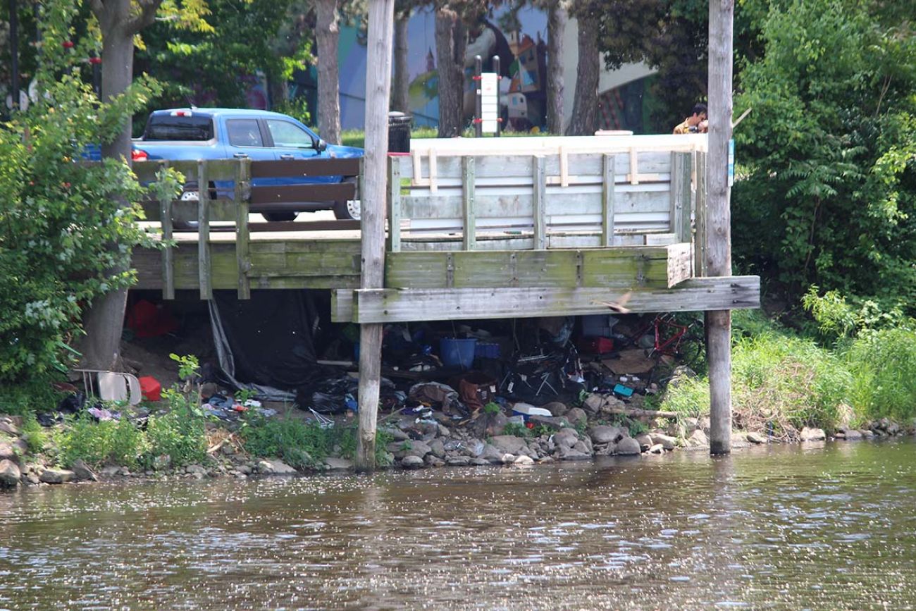 A lot of items like bikes and chairs under a dock in Lansing, MI