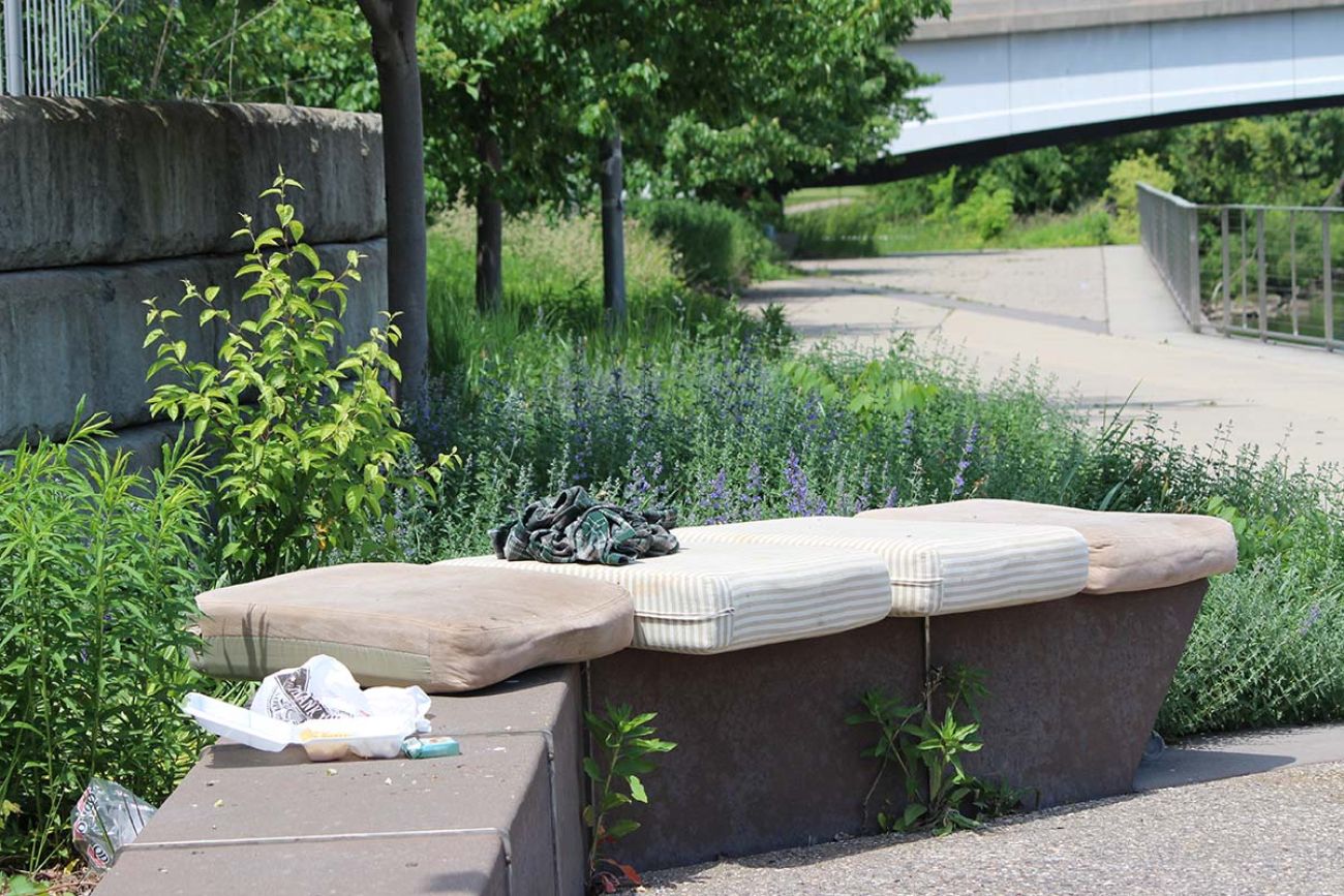 Outdoor furniture cushions on a bench outside