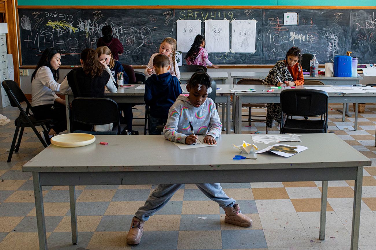 child doing schoolwork in a classroom