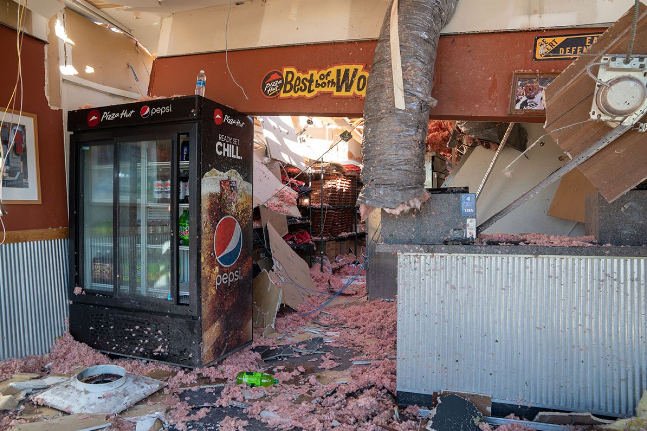 Inside a heavily Pizza Hut, insulation can be seen on the ground