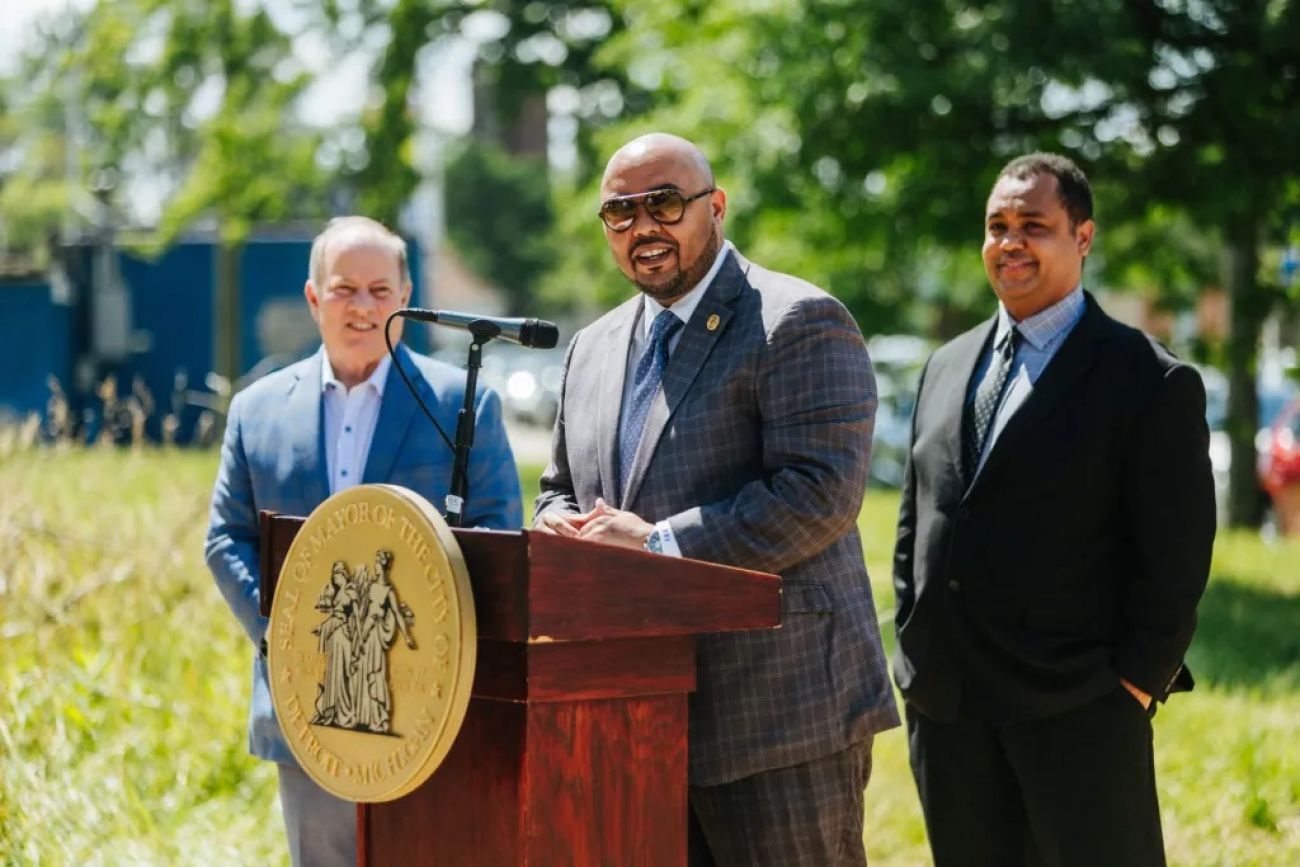 Detroit City Councilman Fred Durhal III speaks into a microphone. He is outside