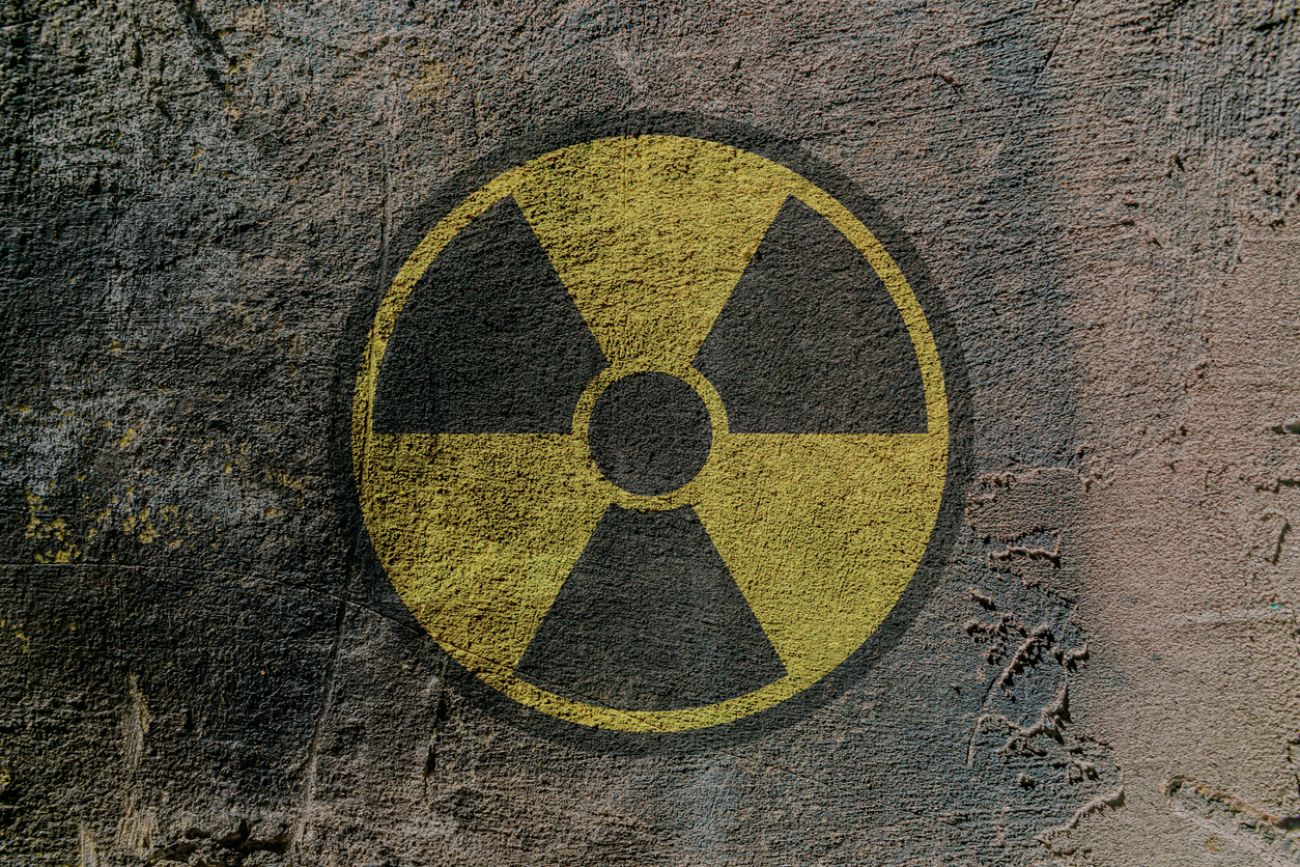 Radiation hazard warning sign depicted on a concrete wall