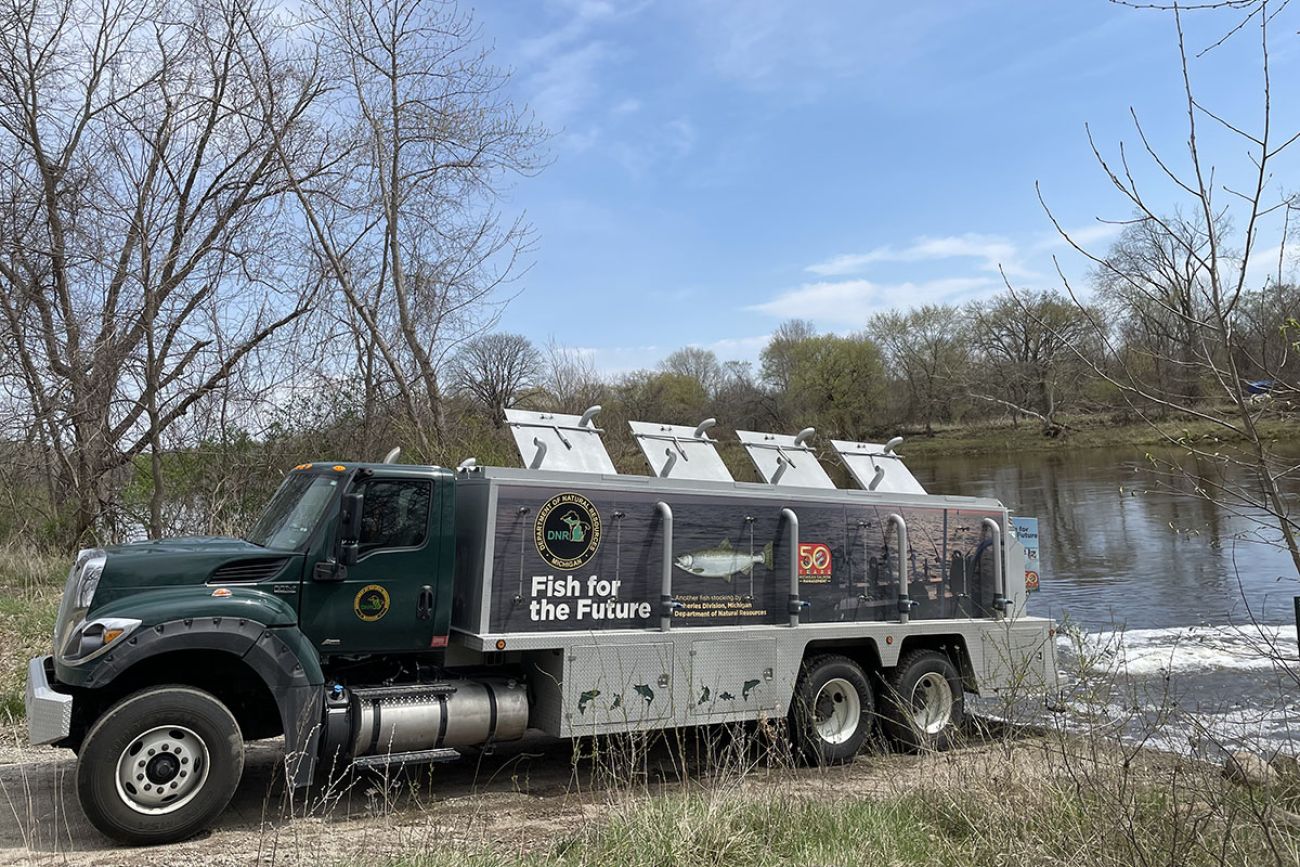 A stocking truck parked right next to the river 