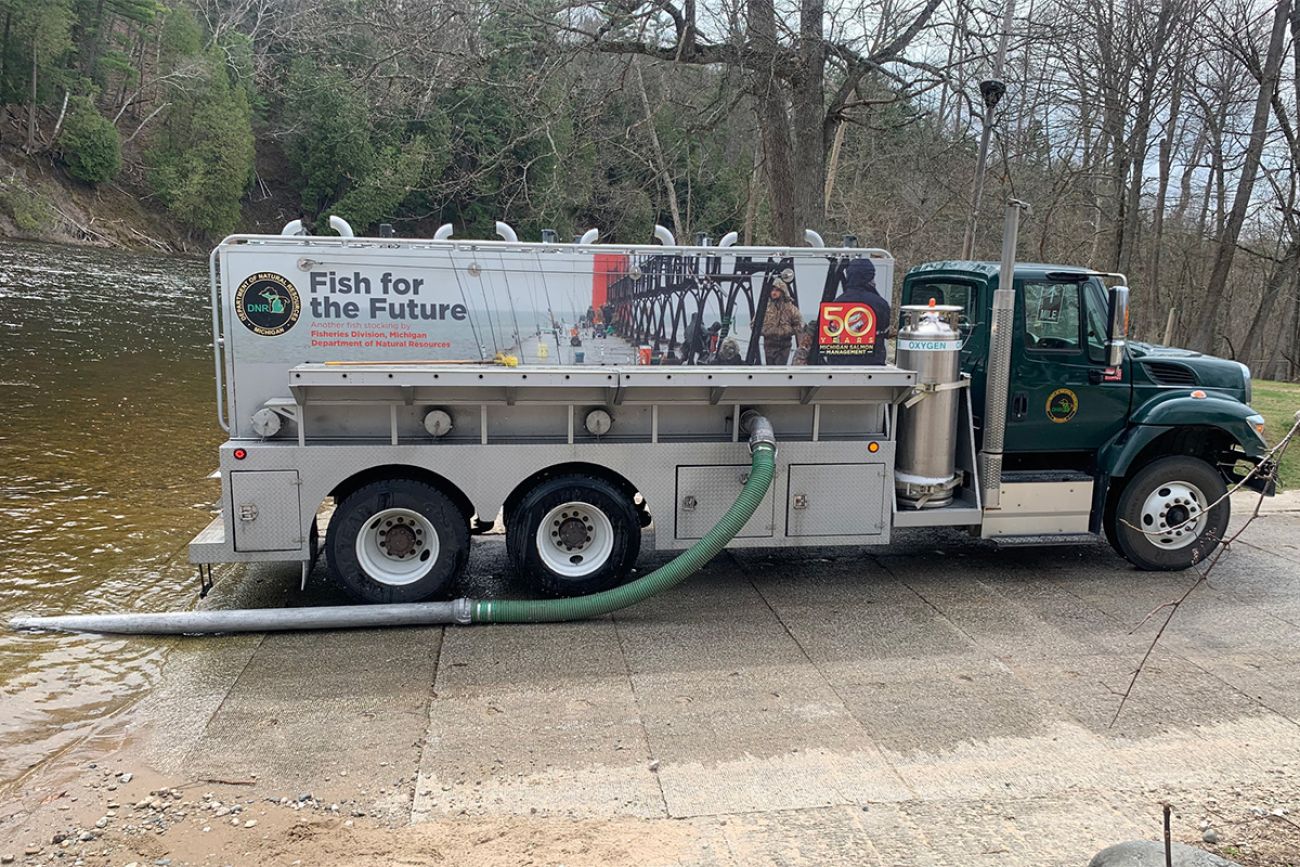 A Michigan DNR specialty stocking truck, which has a hose that goes down to the river