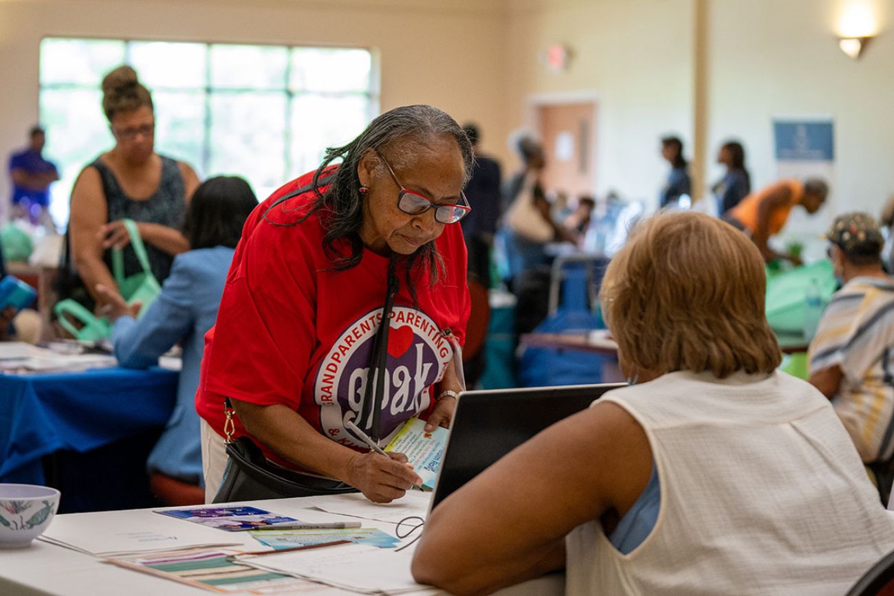 Gwendolyn Swain filling out papers on a table at the event 