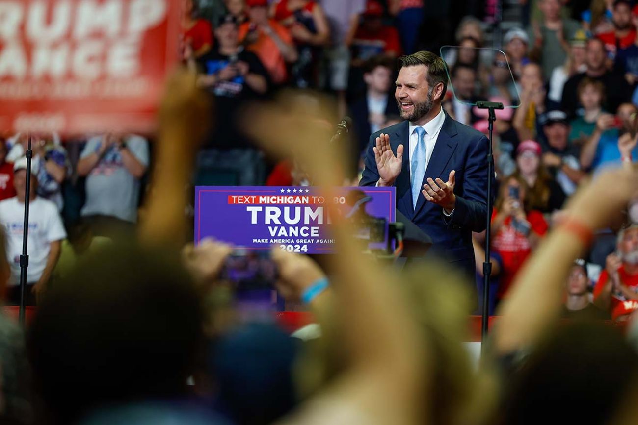 J.D. Vance clapping his hands on stage at a rally