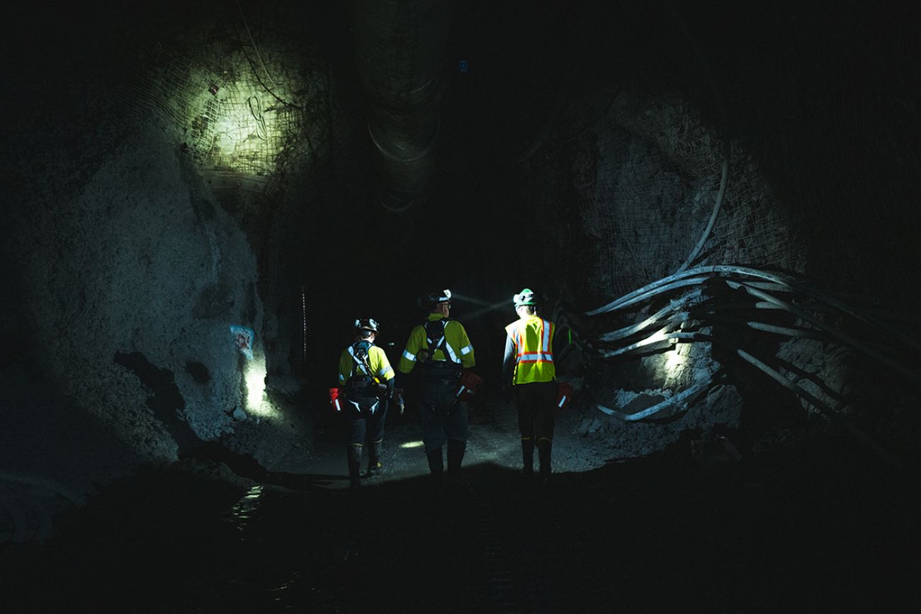 People walking in a dark mine