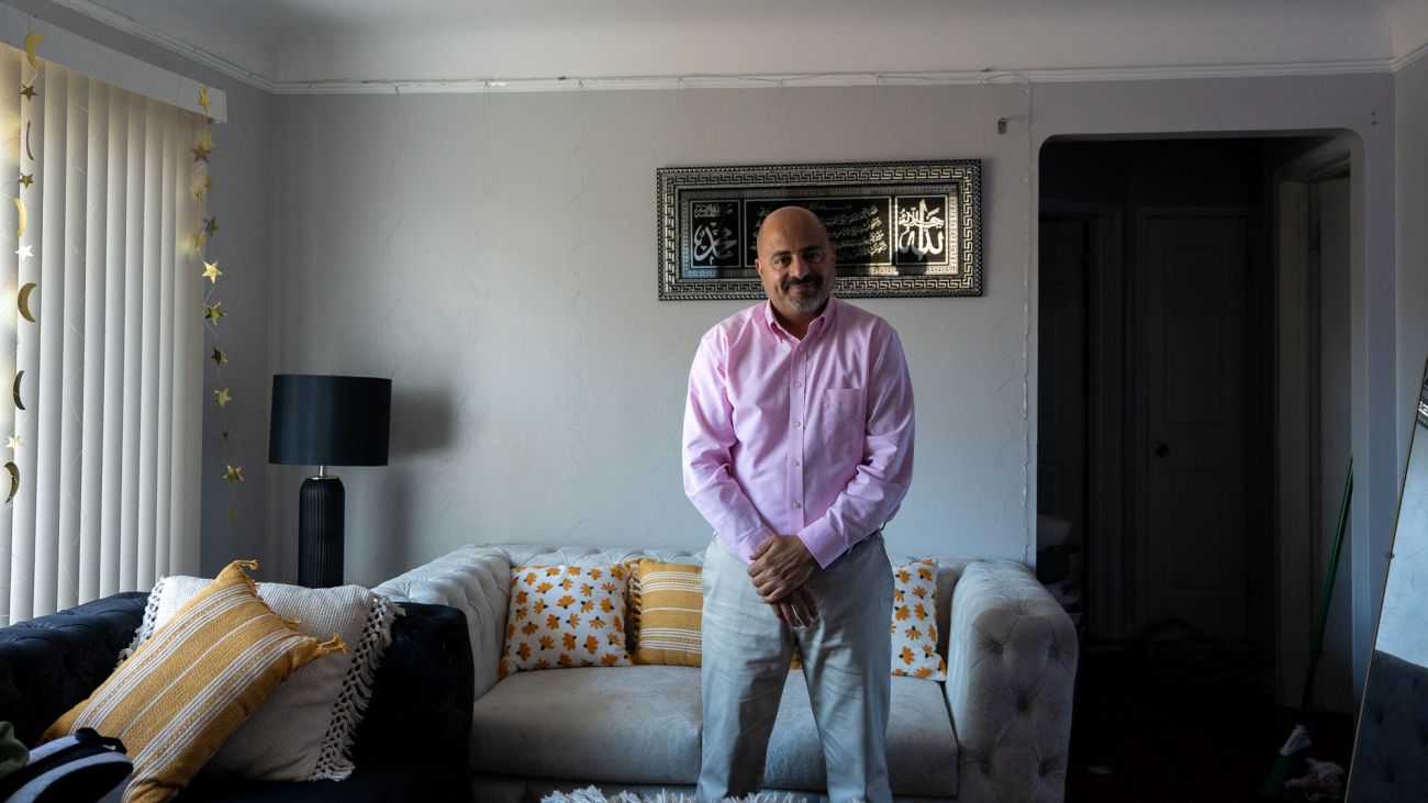 Dearborn resident Nagi Almudhegi standing in a living room