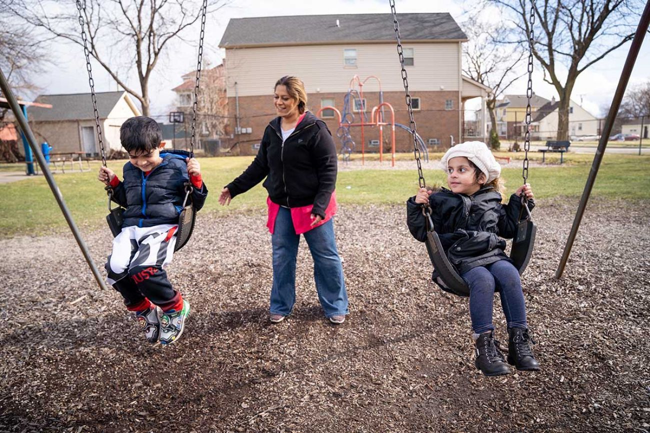 Sumraa Luqman pushing kids on a swing