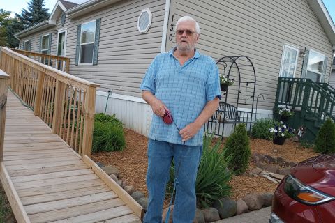 man in front of mobile home