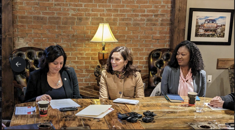 three woman sitting at a table