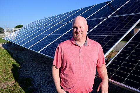 man in front solar panel