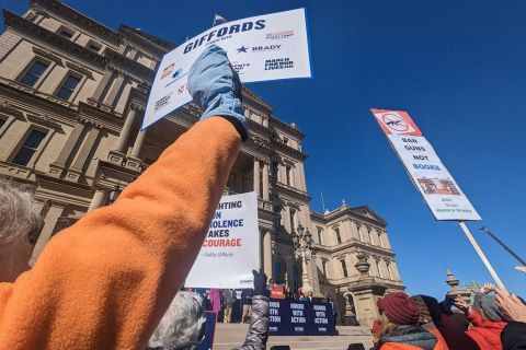 signs supporting stricter gun laws