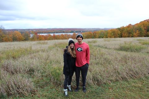 two people standing in a field