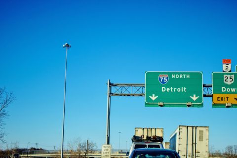  Semi trucks and cars in traffic jam on northbound I 75 heading into Detroit, Michigan.