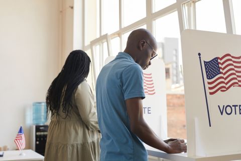 two voters at a voting booth