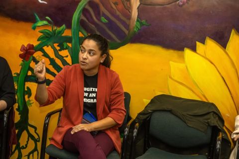 Detroit City Council Member Gabriela Santiago-Romero sitting in front of a mural