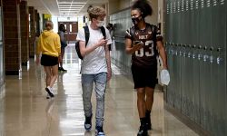 students in the hallway with masks