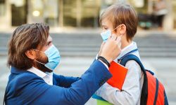 man putting kids with mask on