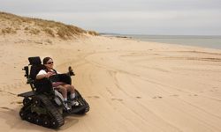 man in wheelchair on beach