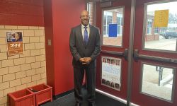 man standing in a school hallway