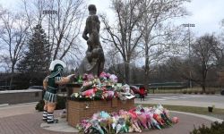 Sparty touches the Spartan Statue