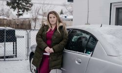 woman standing next to car