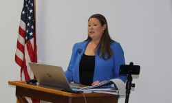 Stefanie Lambert speaking at a podium