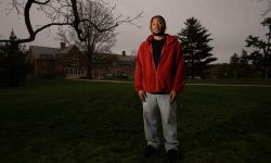 young man with a red hoodie posing for a photo