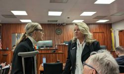 two women standing in a courtroom