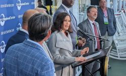 Michigan Gov. Gretchen Whitmer standing next to several people