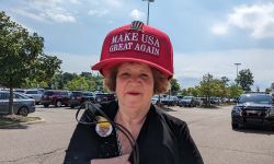 Mary Hamilton wears big red hat that says "Make USA Great Again"