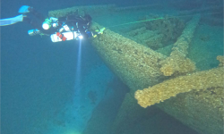 A diver looking at Mojave. The ship looks green now. 